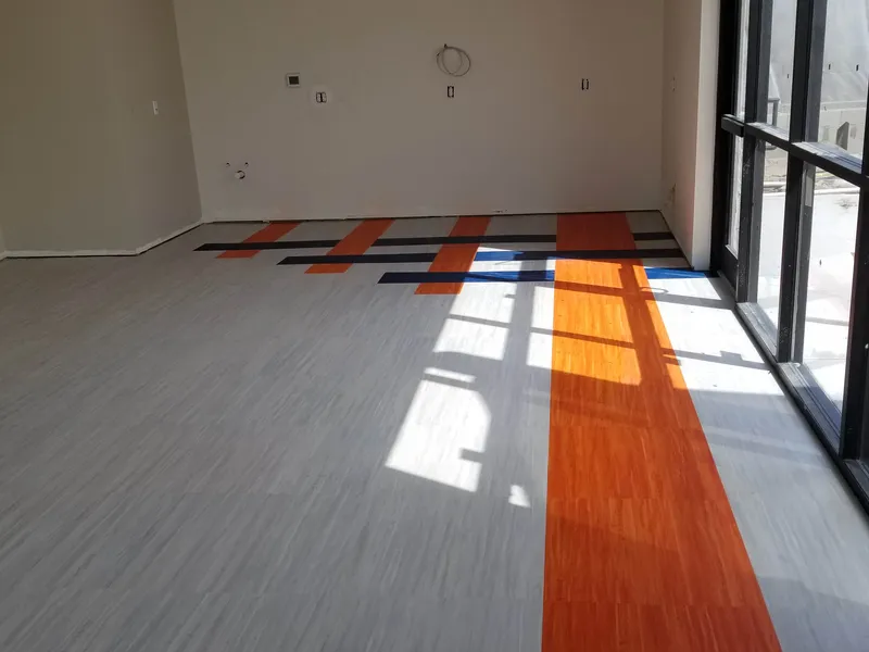 Woven orange-and-navy vinyl plank design floor